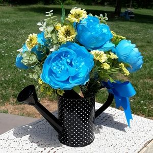 Handcrafted floral arrangement in watering can